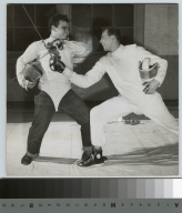 Student activities, two male members of the Rochester Institute of Technology fencing team in a mock engagement with Sabers, 1951