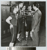Student activities, members of the Rochester Institute of Technology wrestling team with their coach Earl Fuller weighing in, 1952  [picture].