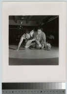 Student activities, portrait of coach Earl Fuller instructing a member of the Rochester Institute of Technology wrestling team,