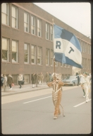 Spring weekend parade, Rochester Institute of Technology tiger mascot carrying the Rochester Institute of Technology flag, [1963]