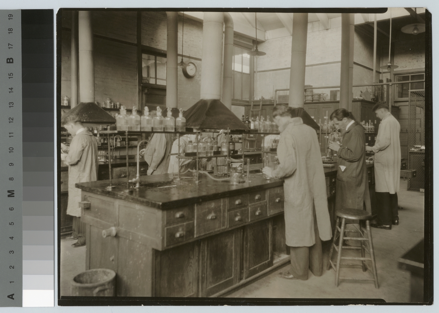 Academics, chemistry, Rochester Athenaeum and Mechanics Institute chemistry laboratory in the Eastman Building with male students working on experiments, [1920-1930]