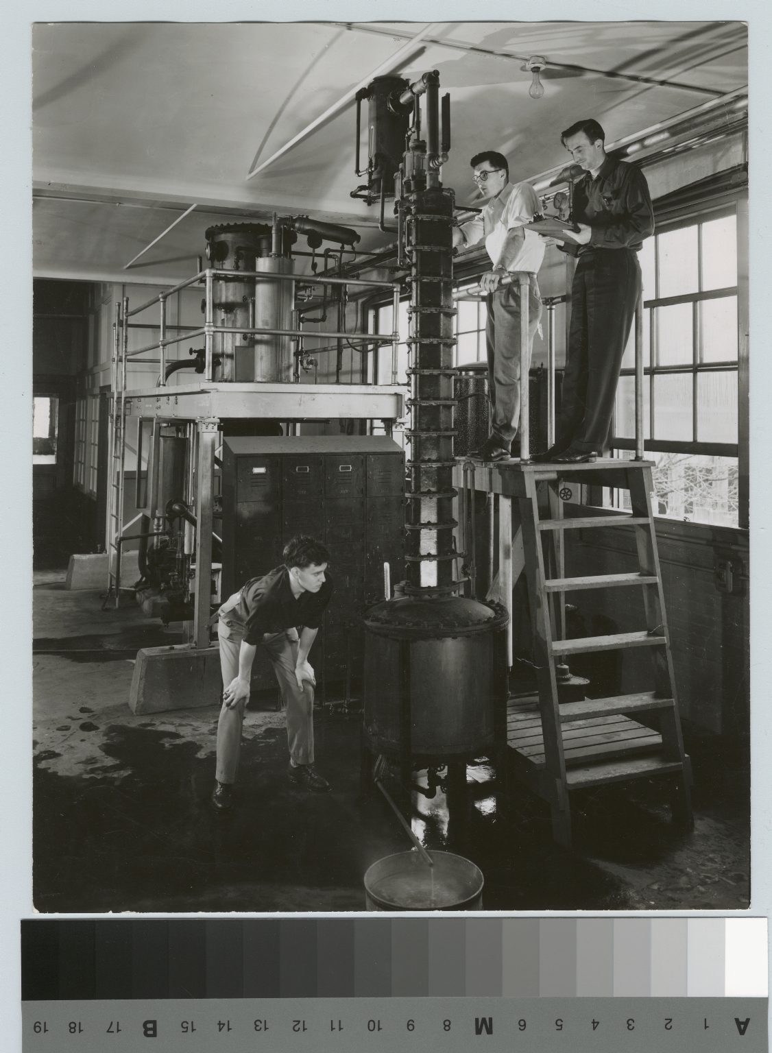 Academics, chemistry, three male Rochester Institute of Technology students working with industrial chemical equipment, [1945-1960]