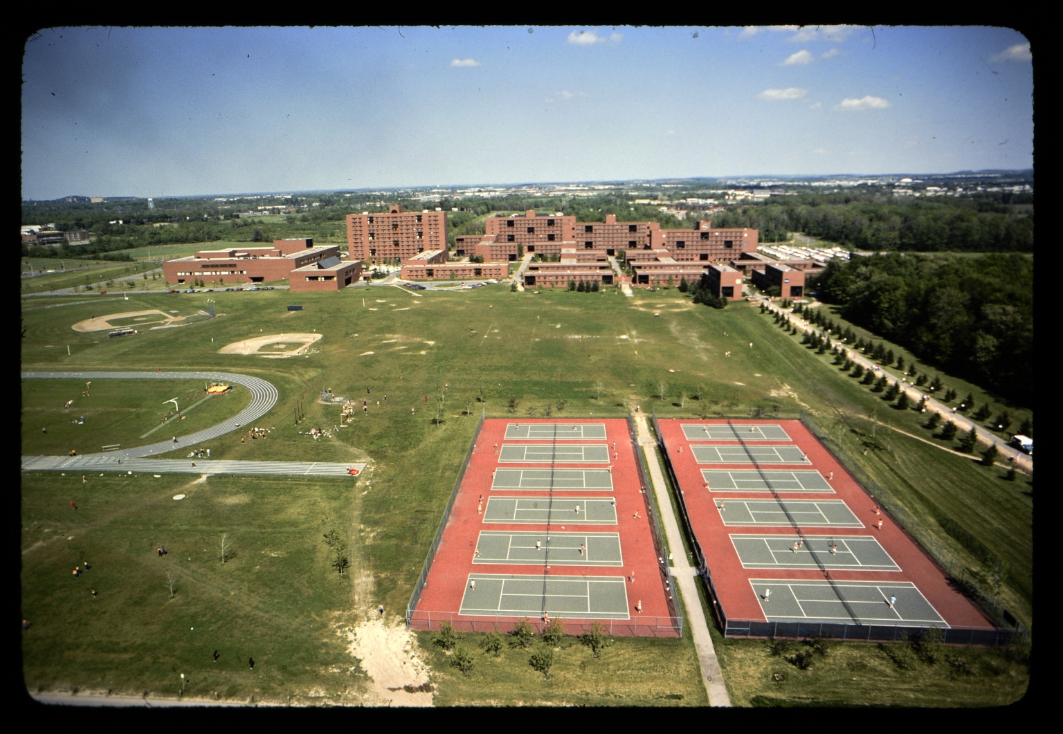 Aerial view of tennis courts and dorms