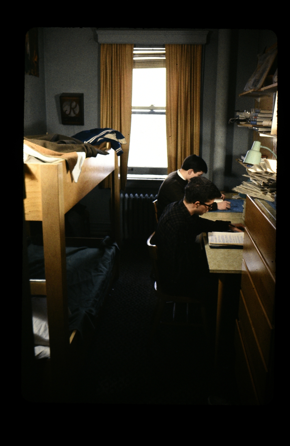 Interior of a college dorm room with students
